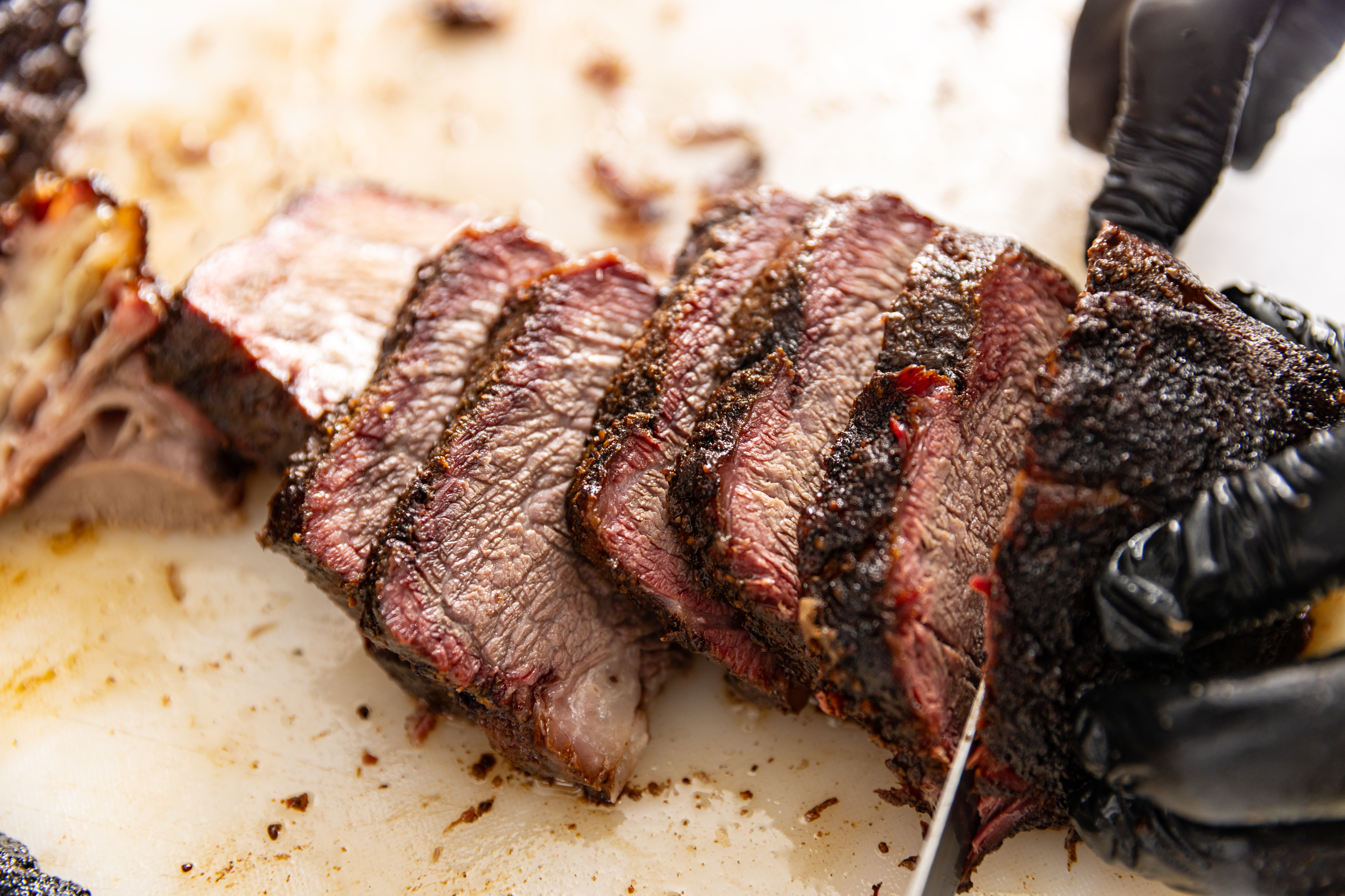 Sliced smoked brisket on a cutting board